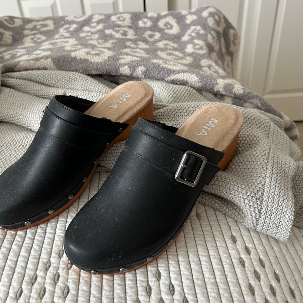 Black studded Mia clogs.